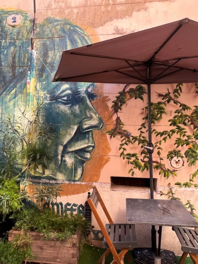 Mural of a lady on a peach coloured wall, Marseille