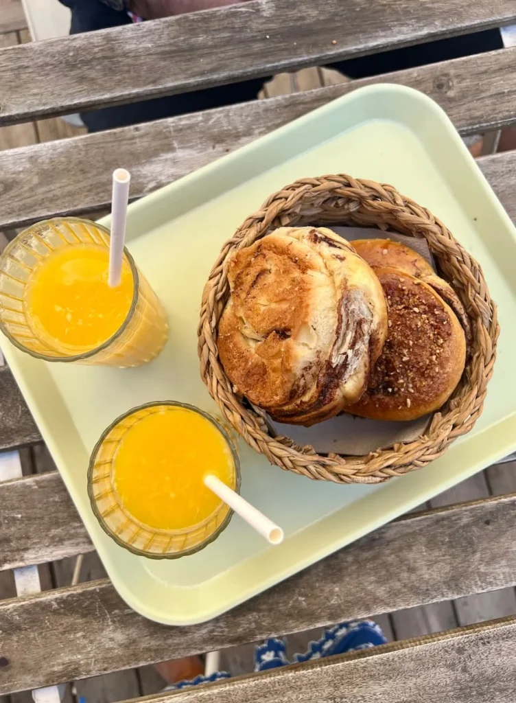 Flat lay of orange juice and breakfast pastries at the terrace of Maison Geney, Marseille