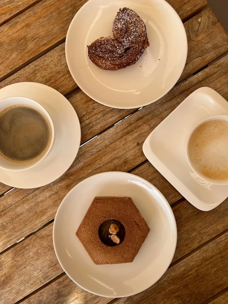 Flat lay of pastry, chocolate palmier and coffees at La Pépite, Marseille