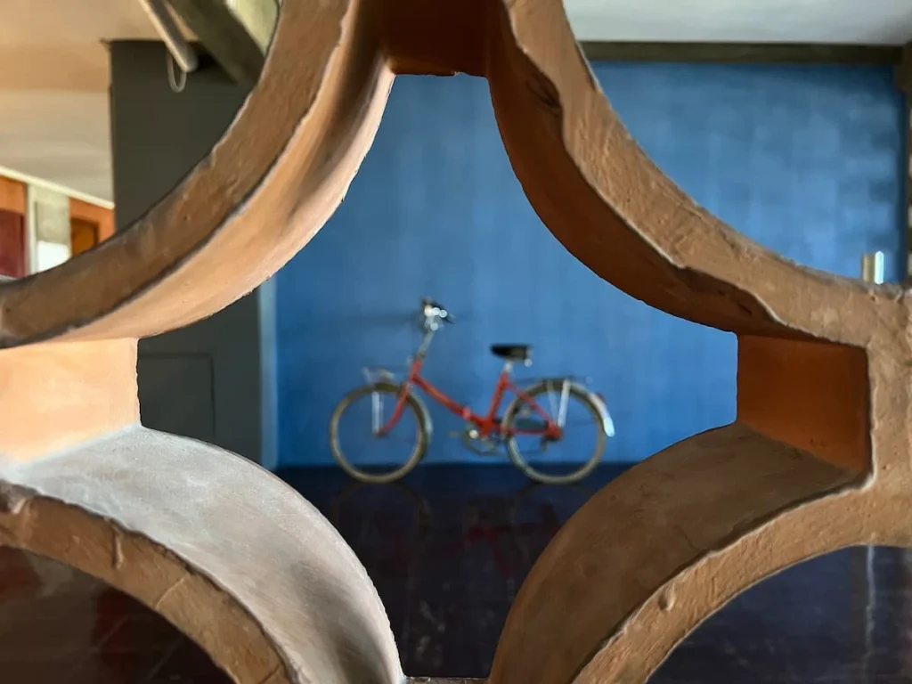 A bicycle view through a goldgrid at Cité Radieuse Le Corbusier, Marseille