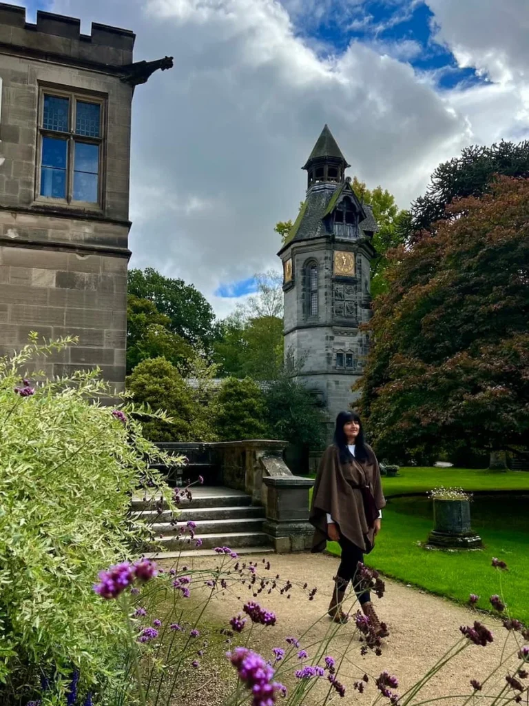 The clock tower at Hampton Manor with Bejal walking along path infront