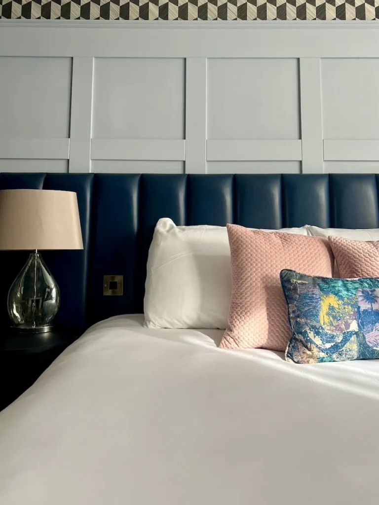 Cushions, headboard and lamp close-up on bed in superior double room at St Martins Lodge, Leicester