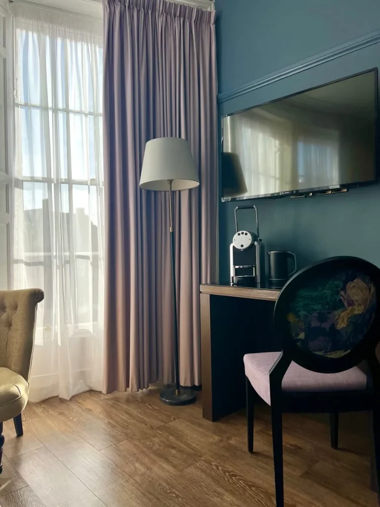 desk, TV and lamp in superior room at St Martins Lodge, Leicester