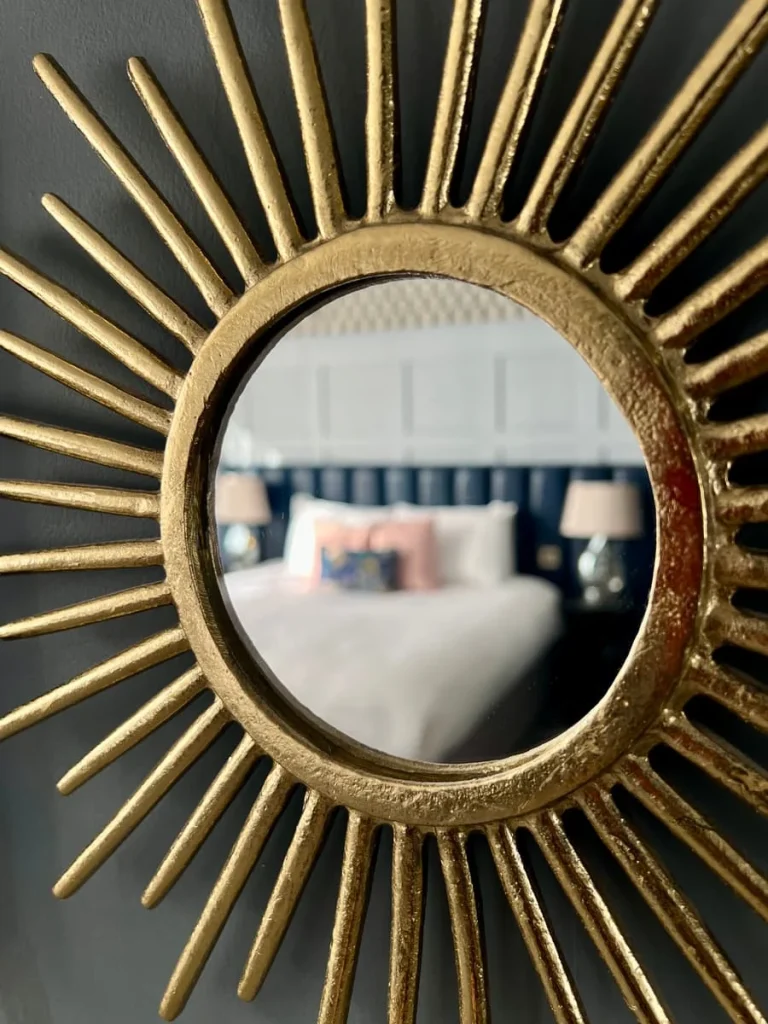 Bed reflection in gold mirror in superior room at St Martins Lodge, Leicester