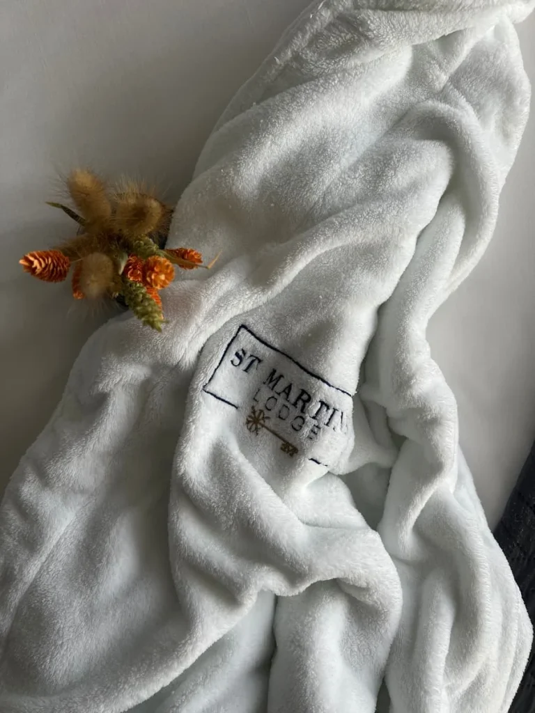 Bath robe on bed with dried flowers at St Martins Lodge, Leicester
