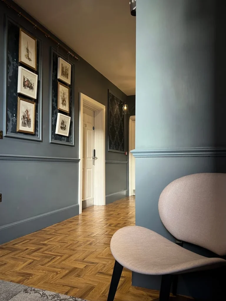 Hallway with chair and sketches at St Martins House, Leicester