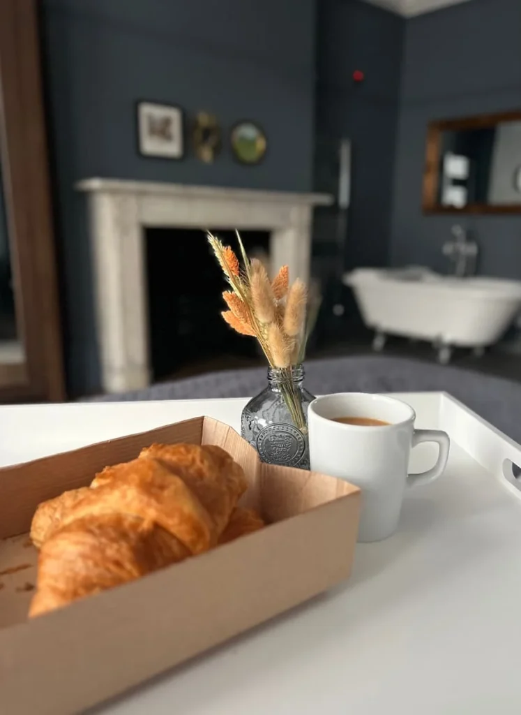 Croissants and tea on bed of superior room of St Martins lOdge, Leicester