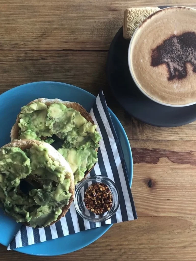 Bagel topped with avocado, chilli flakes and a cappuccino at Orso