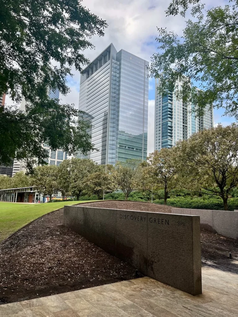 Sustainable Houston Guide:  Discovery Green Park with skyscrapers in the back