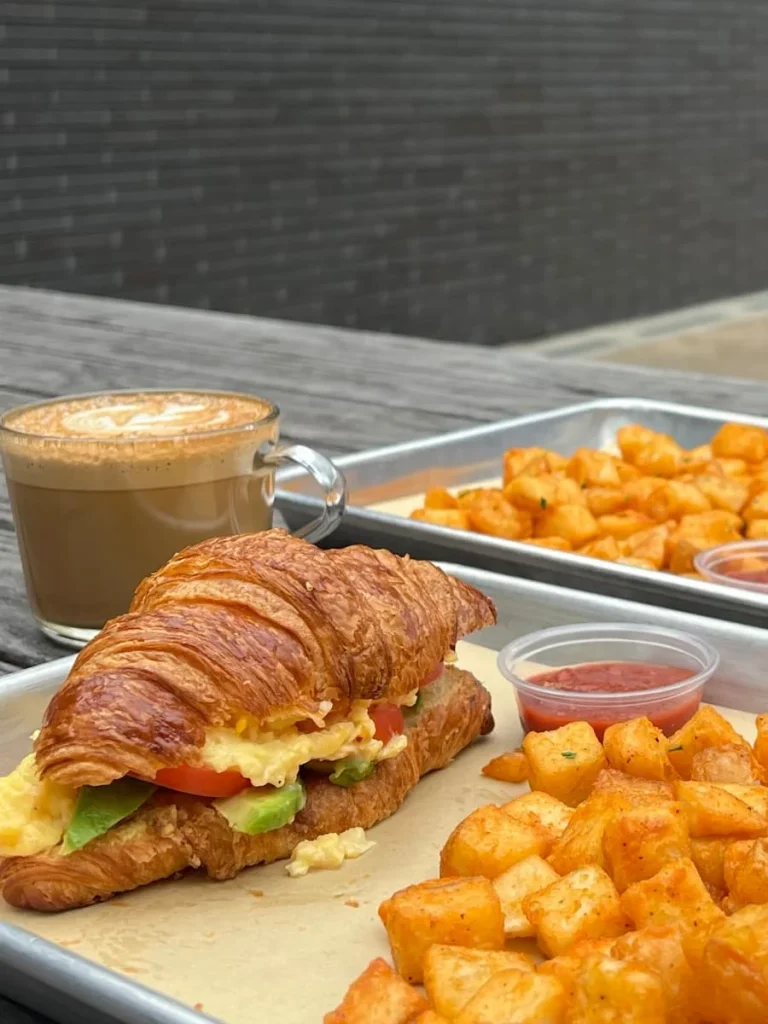 Cappuccino and breakfast croissany with potatoes at Tout Suite, Houston