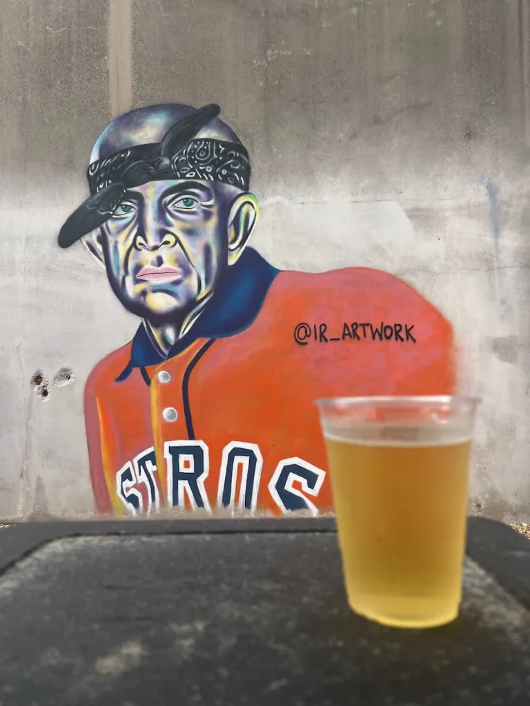 Street art in back yard with beer glass infront at 8th Wonder Brewery