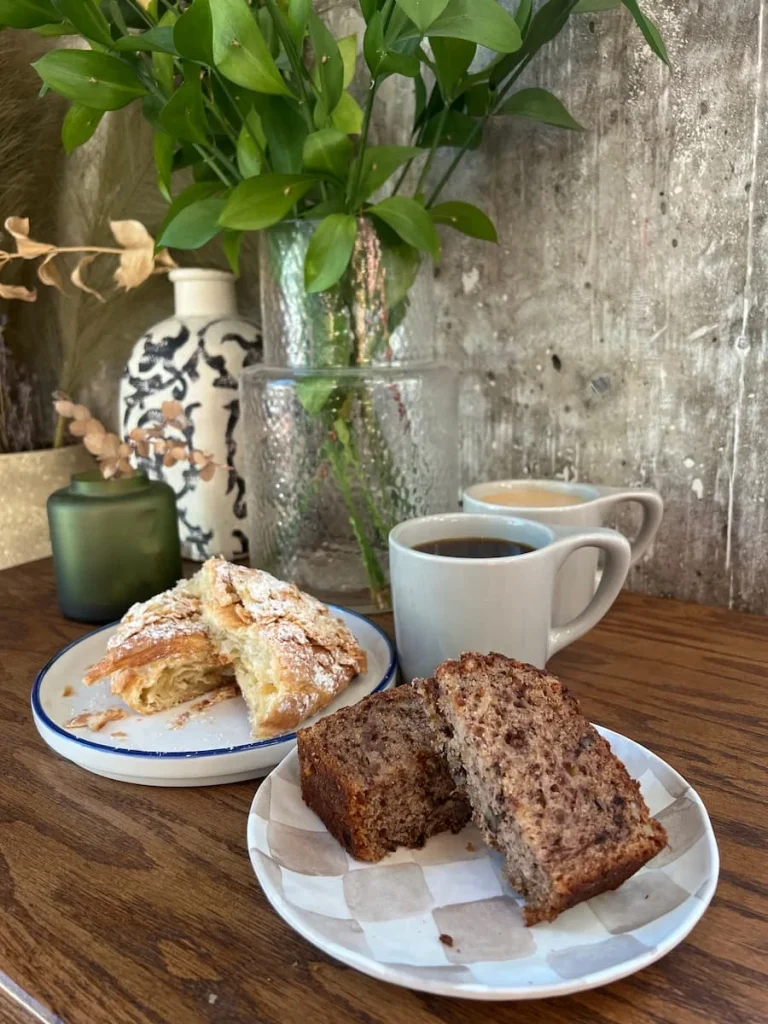 Almond croissant, banana bread, black drip coffee and cappuccino at Fifth Vessel, Houston