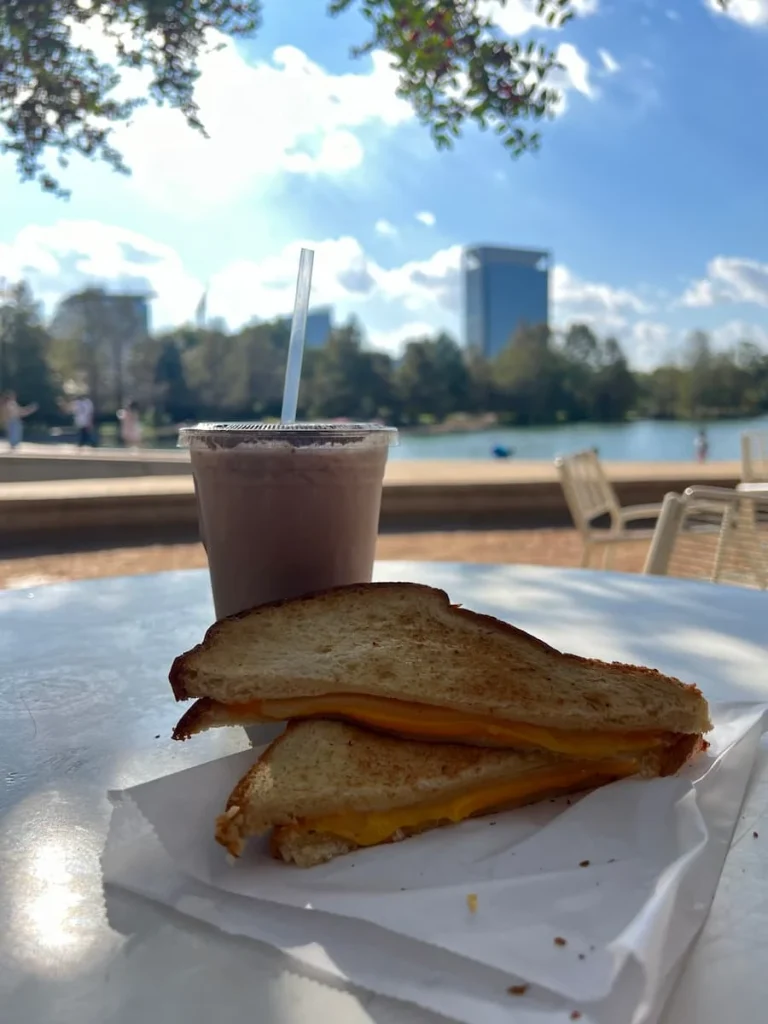 Grilled cheese and iced chai latte overlooking the lake at Sunday Press in Hermann Park, Houston