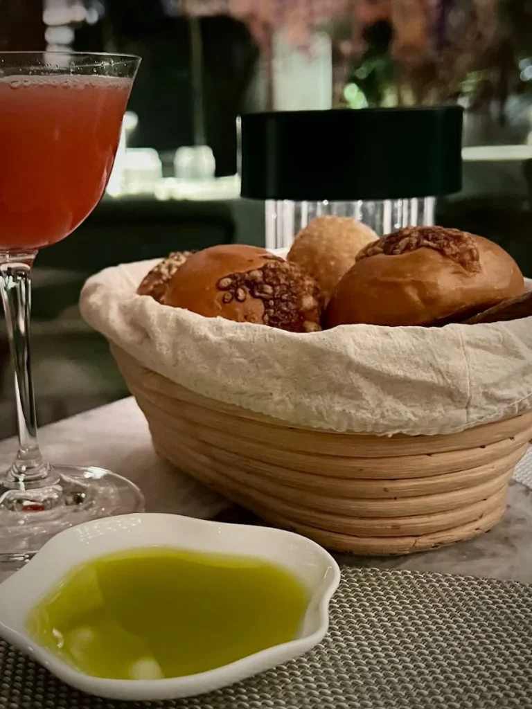 Vegetarian food in Houston: Le Jardinier cocktail with bread basket and extra virgin olive oil