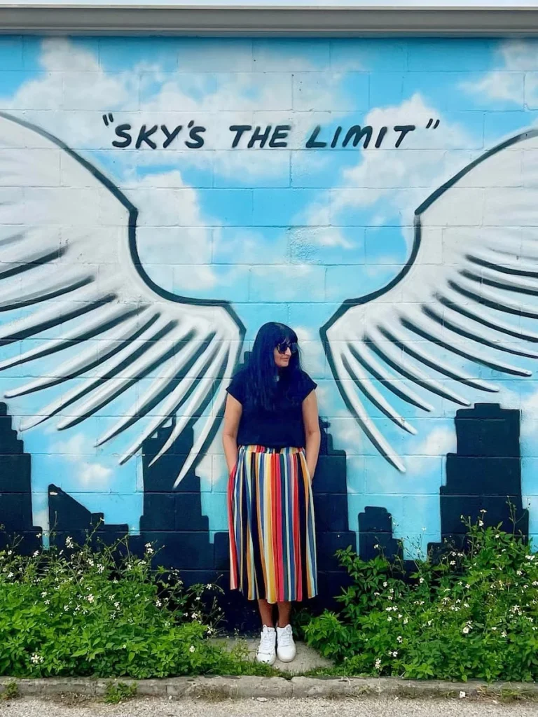 Photo locations in Houston: Graffiti Park Skys the Limit Wings with Bejal standing infront