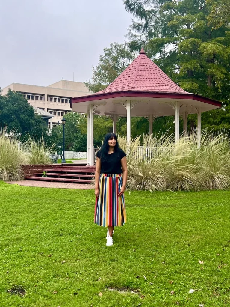 photo locations in Houston: Band Stand/Gazebo at Sam Houston Park with Bejal standing in front 