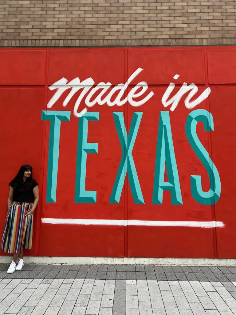 photo locations in Houston: Houston made in Texas Mural with Bejal standing against wall