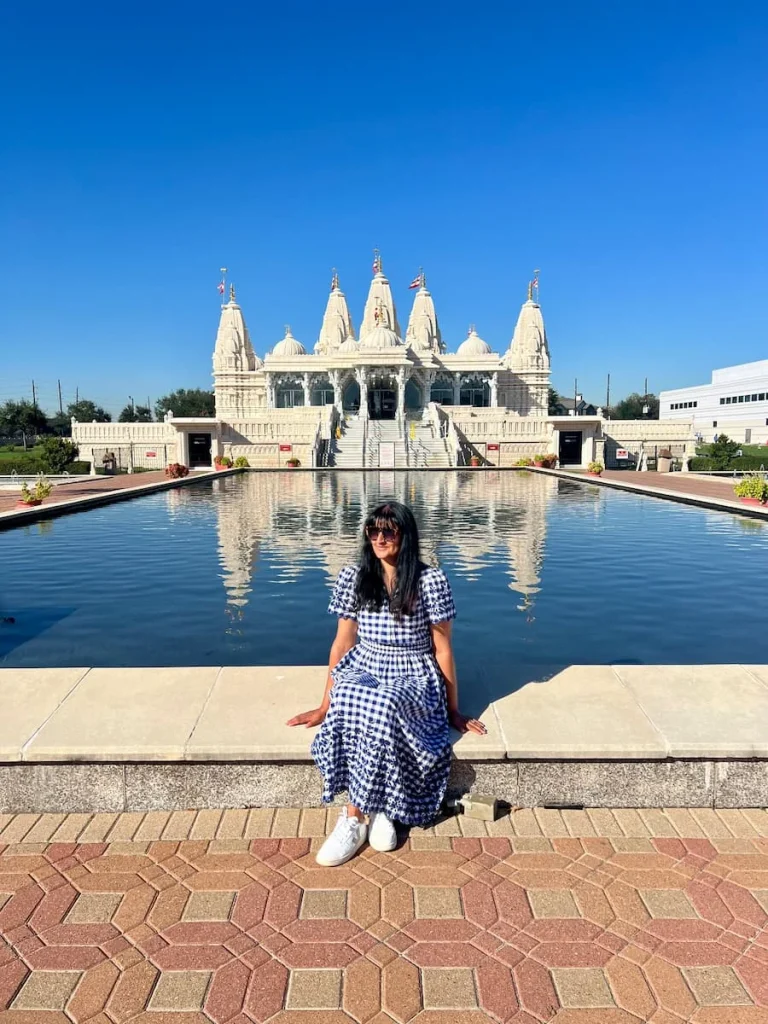 photo locations in Houston: BAPS Swaminarayan Temple with Bejal sitting in front of the pond