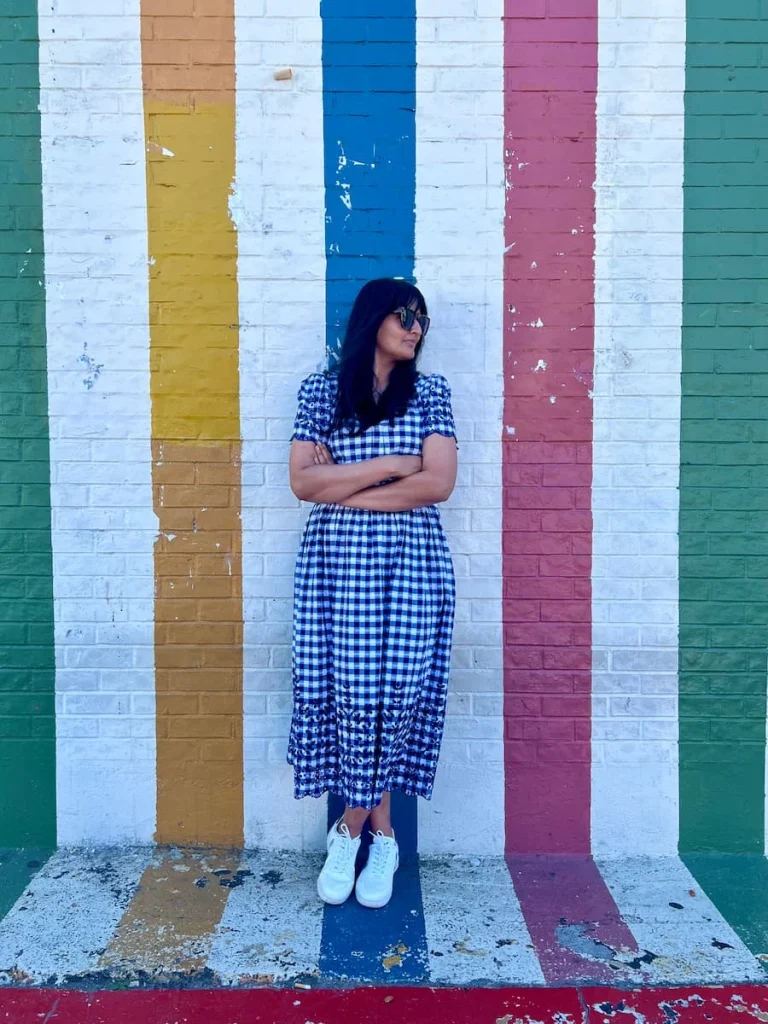 Photo locations in Houston Montrose colourful stripe wall with Bejal standing in front