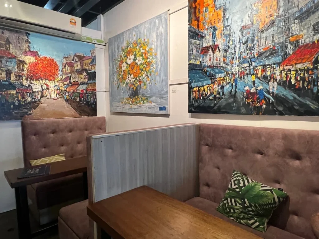 Vegan and Vegetarian food in Langkawi: Arts cafe interiors with artwork hanging on the walls