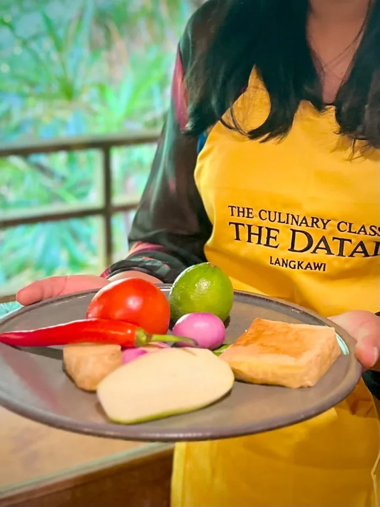 Bejal carrying a plate of vegetables at The Datai Langkawi
