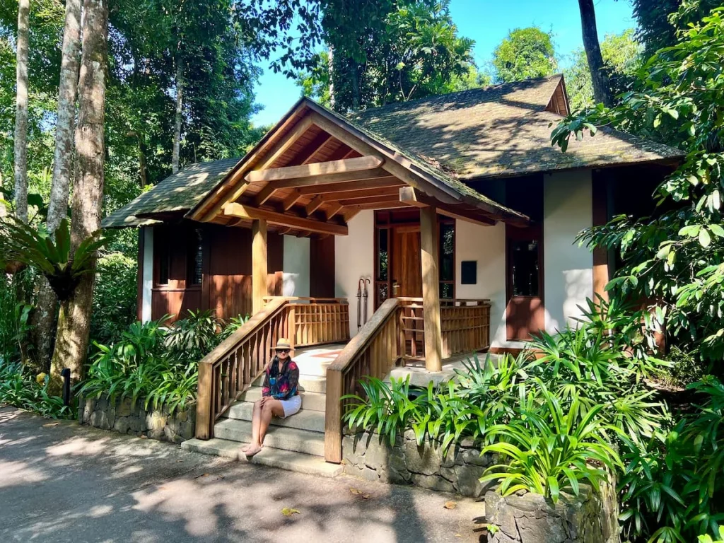Bejal sitting outside a rainforest villa wearing black top adn white shorts at The Datai Langkawi