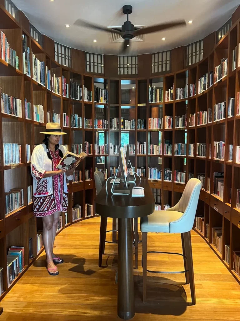 Sustainable luxury Datai Langkawi: Bejal standing in front of book shelves at The Library at The Datai Langkawi