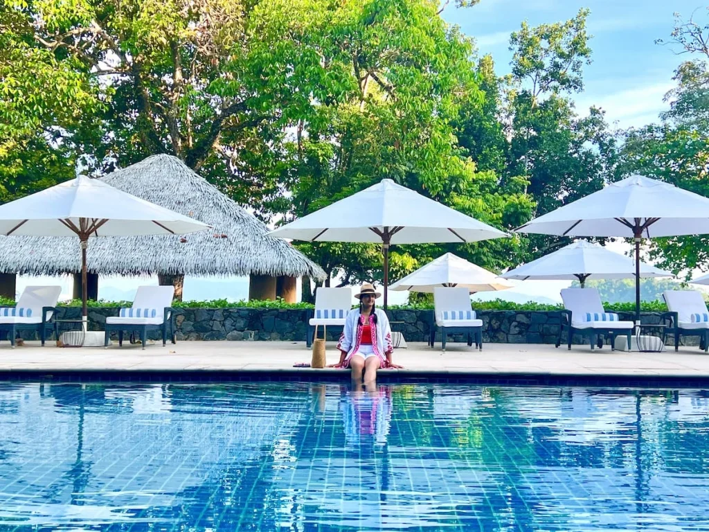 Bejal walking across sun loungers at family pool at the Datai Langkawi