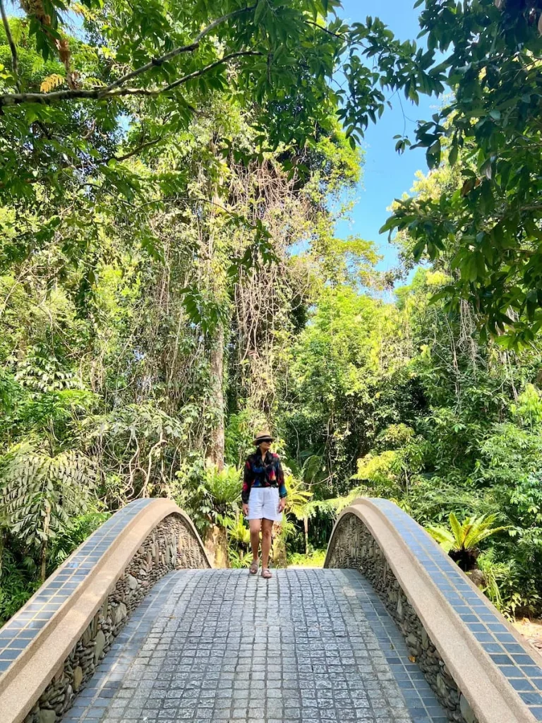 Bejal walking over bridge near rainforest villa at The Datai Langkawi