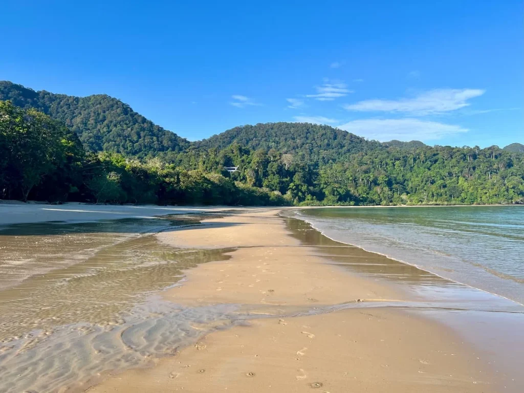 Things to do in Langkawi: The Datai Bay beach with. turquoise waters adn lush rainforest after a beach clean-up