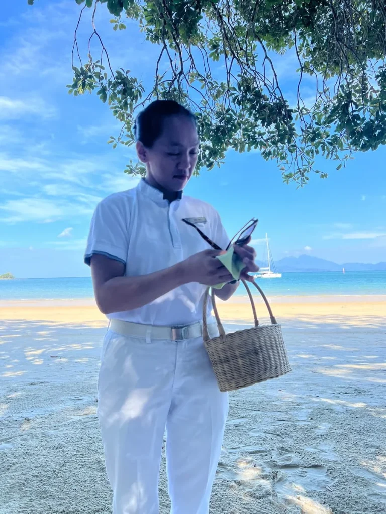Datai Langkawi beach staff cleaning Bejal's sunglasses on the beach