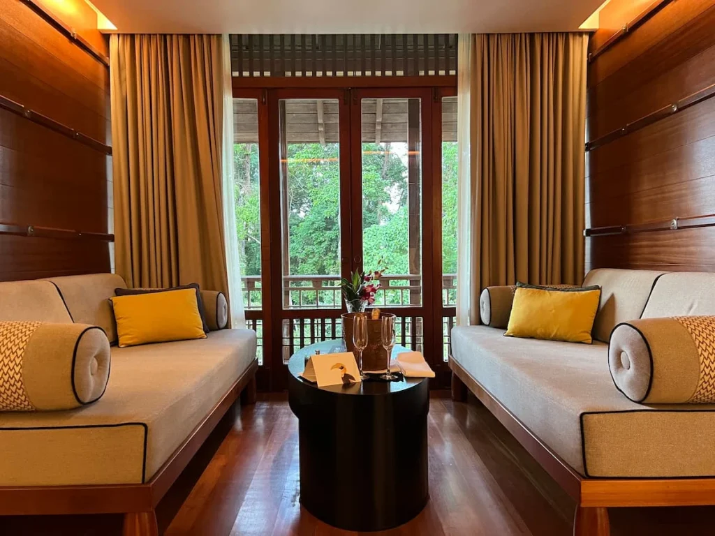 Day beds next to the double doors to the balcony in a premium room at The Datai Langkawi