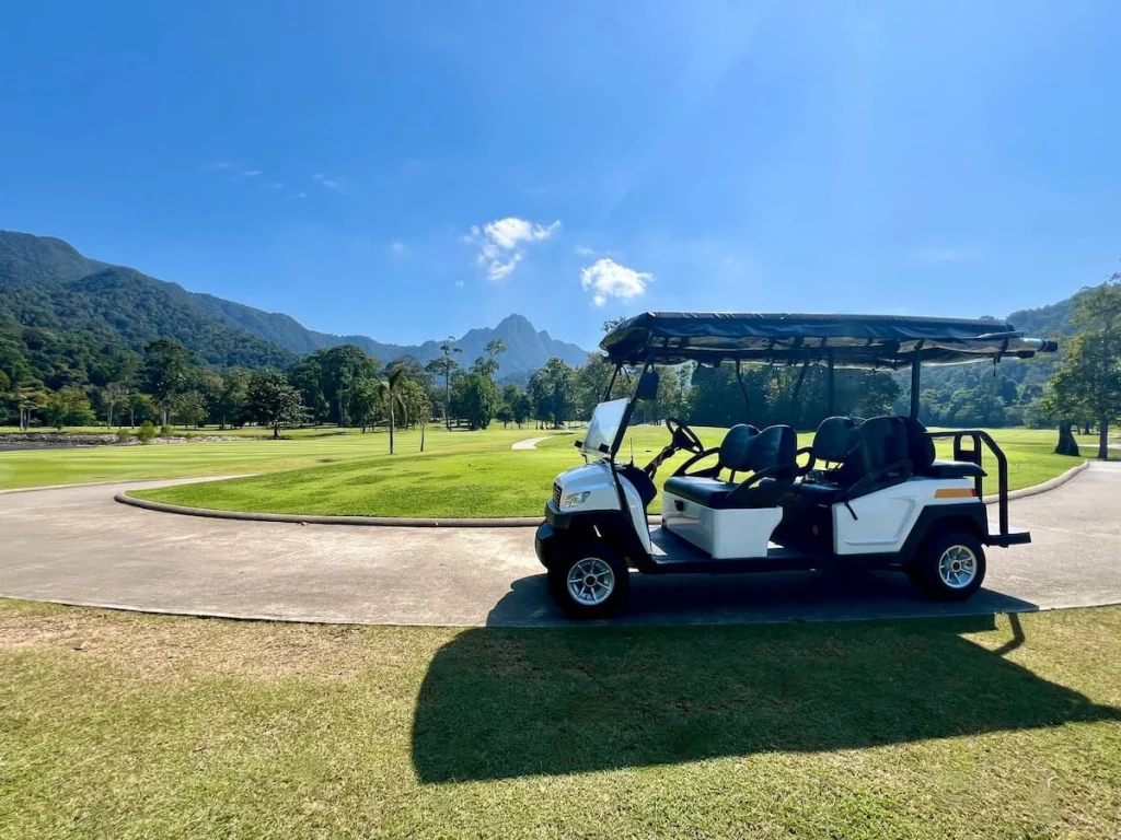 Sustainable luxury Datai Langkawi: Sustainable luxury Golf Cart in front of mountain and golf green at Els Golf Club, Teluk Datai