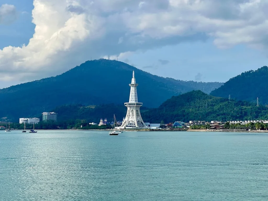 Things to do in Langkawi: Maha Tower with mountains in the background and sea infront of iyt.