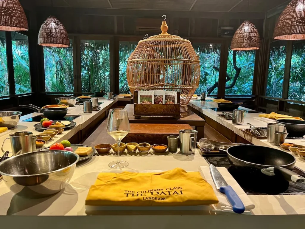 Things to do in Langkawi: Malay cookery class at The Datai Langkawi with aprons, vegetables, spices and cooking stations all set-up for the class.