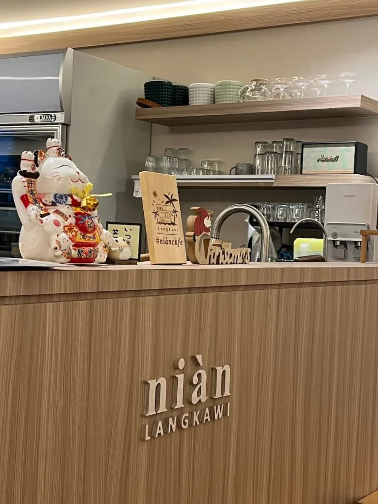 Vegan and Vegetarian food in Langkawi: Nian Cafe counter with various artefacts