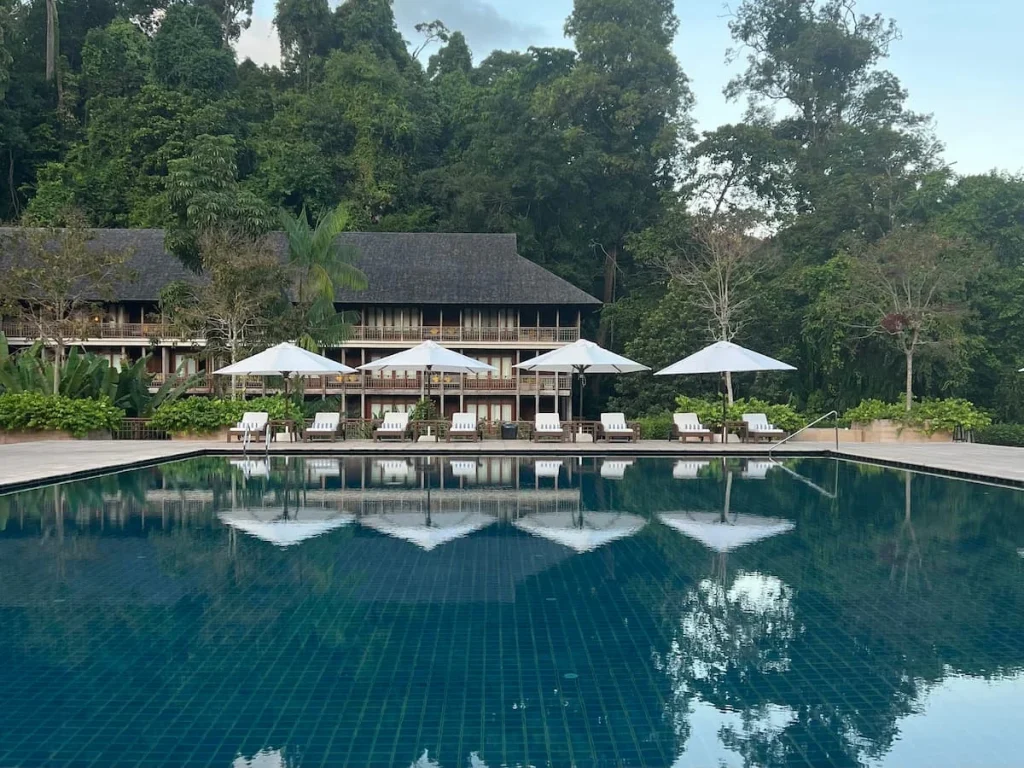Sunbeds and white umbrellas at Main Pool at The Datai Langkawi