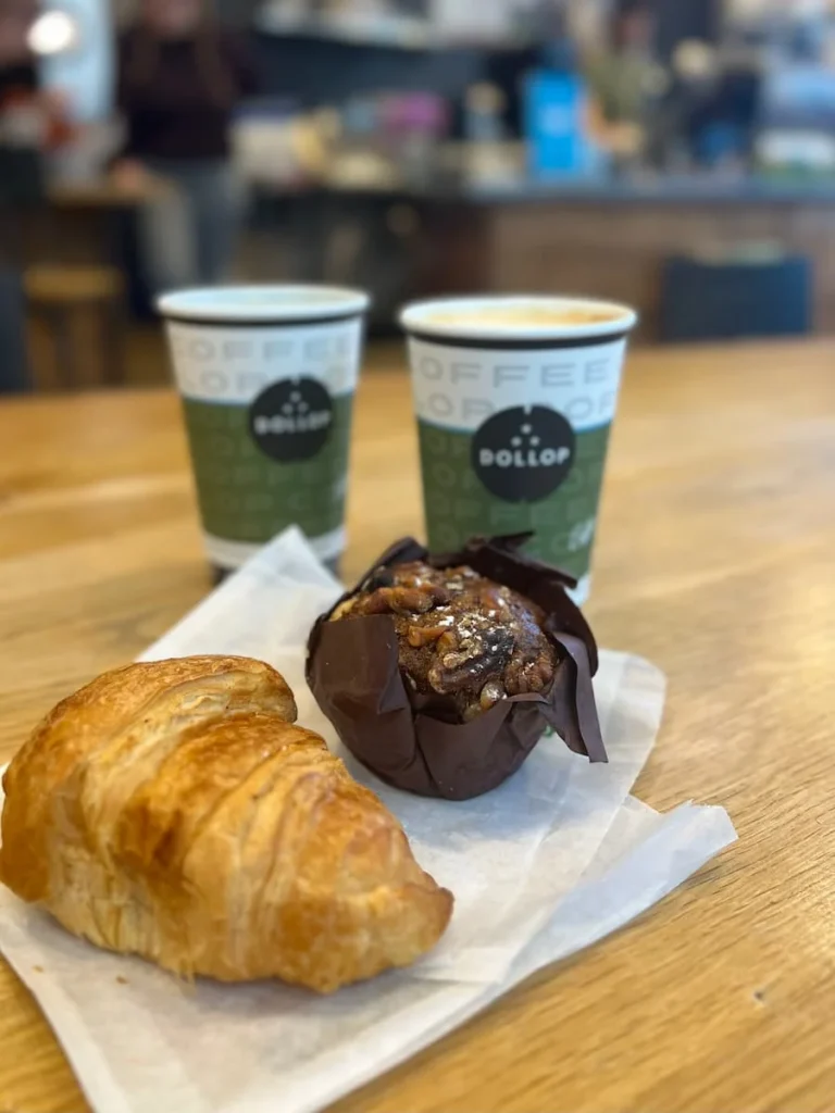 A Coffee and breakfast muffin with a butter croissant at Dollop Coffee, Chicago