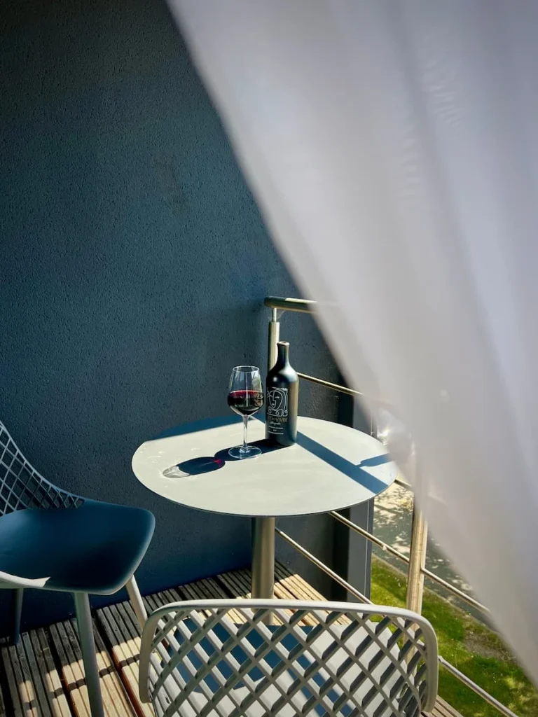 Bottle of wine and wine glass on balcony of Cnacellor's Suite, Burleigh Court Hotel, Loughborough