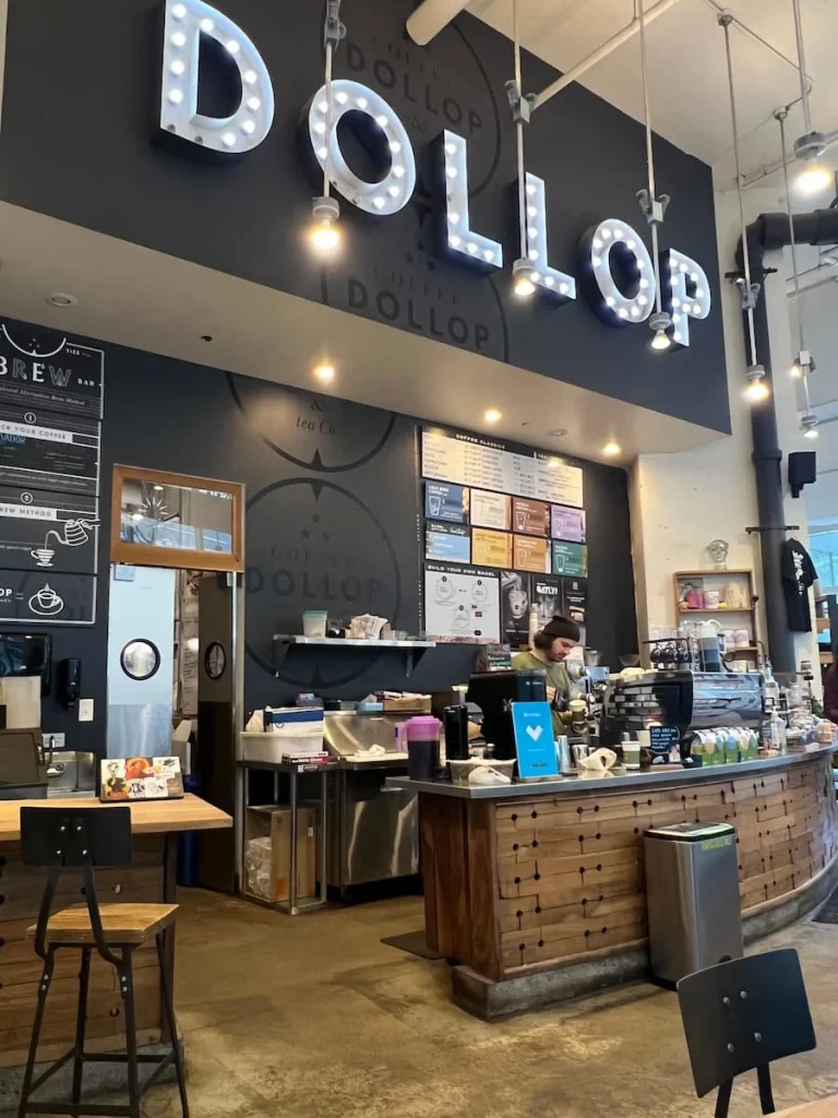 Dollop Coffee counter with Lights sign and server. One of the coffee shops in Chicago for Vegetarians
