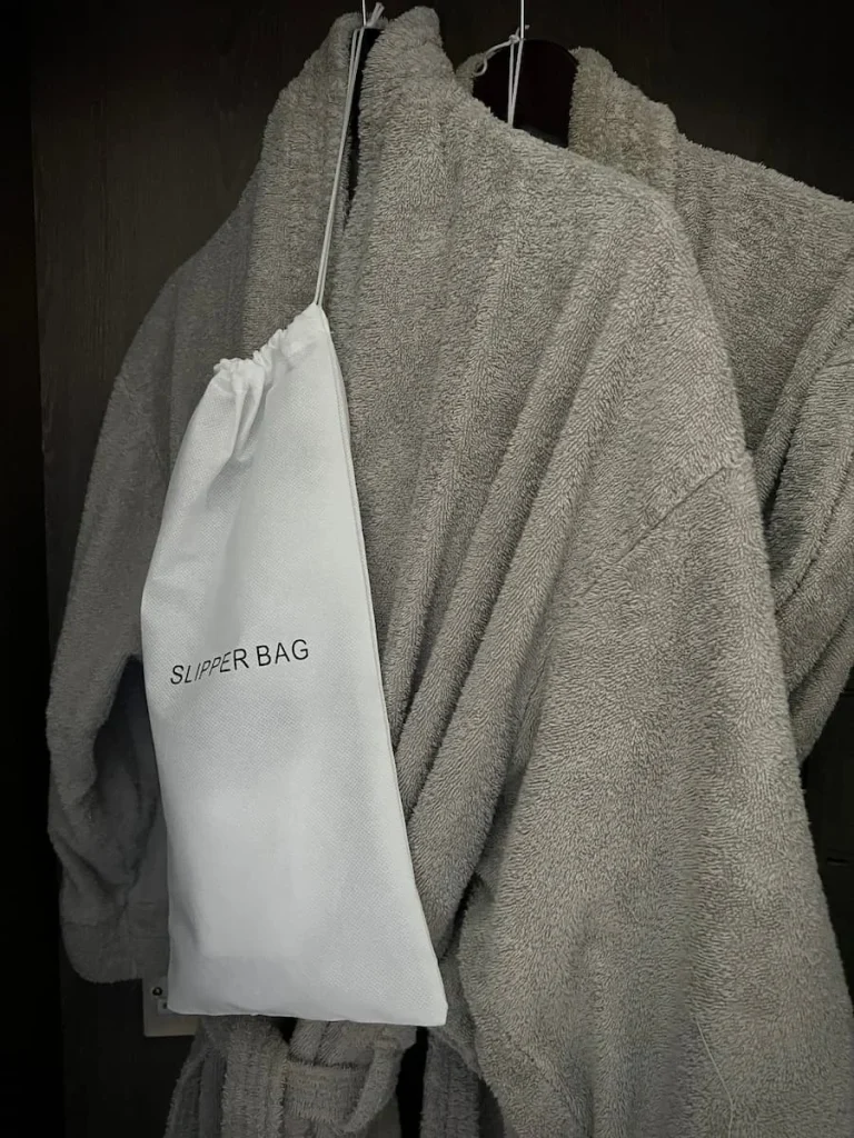 Dressing gown with slippers in a bag in the Chacellor's Suite at Burleigh Court Hotel, LoughboroughRoom for trees