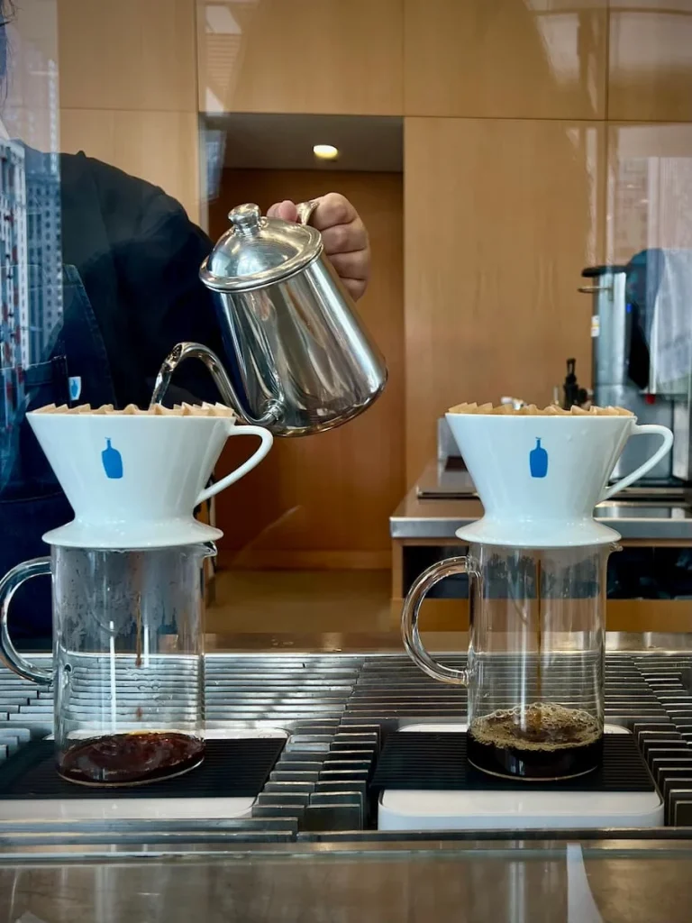 Drip coffee being made at the counter by a barista at Blue Bottle Coffee, Chicago