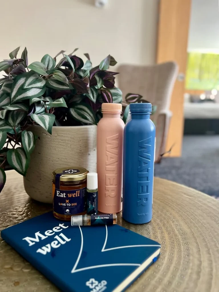 Goodie bag with notebooks, local honey, reusable water bottles and lavender sleep spray in Chancellor's Suite room at Burleigh Court Hotel, Loughborough