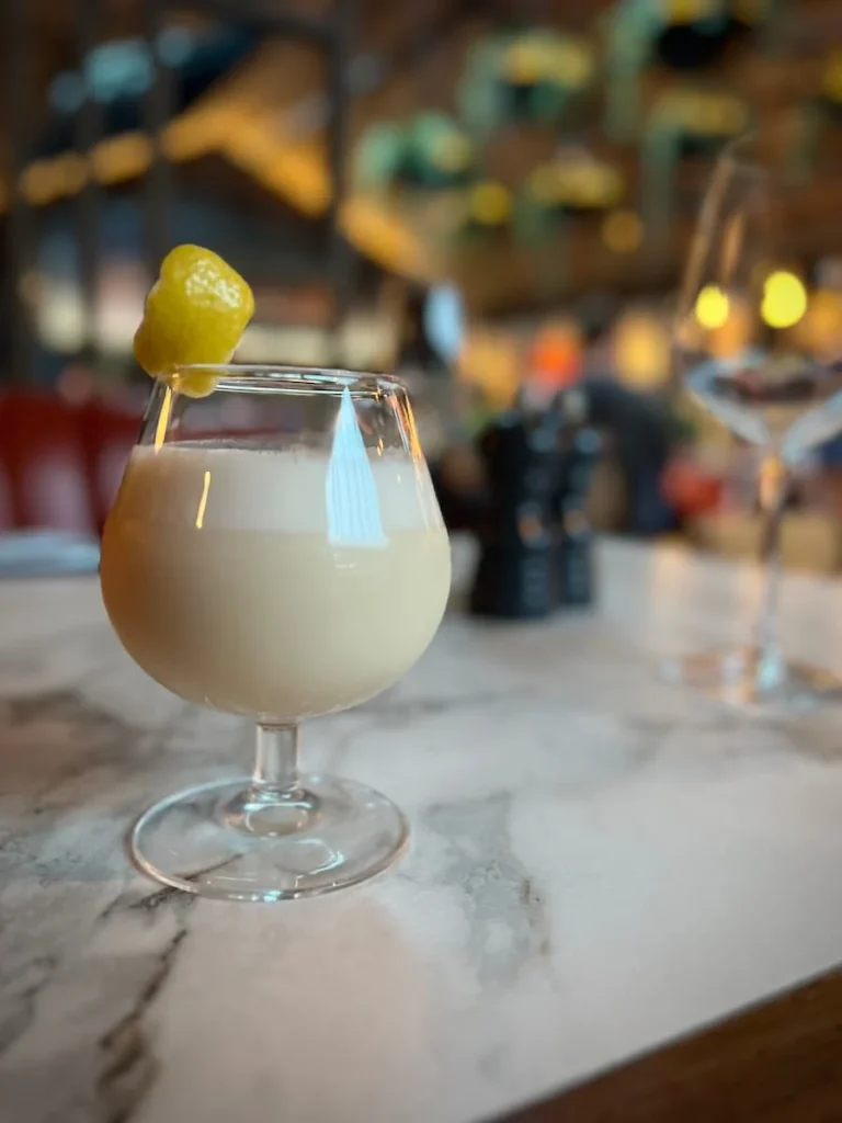 The Peaches and Cream Cocktail with the bar in the background at Fifty The Street, Loughborough