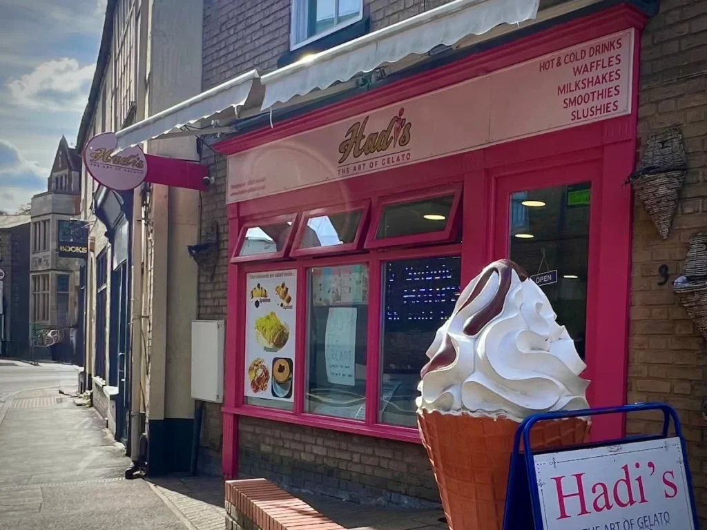 The pink exterior of Hadi's Gelato in Ely wit a big fake My Whippy ice-cream at the front entrance