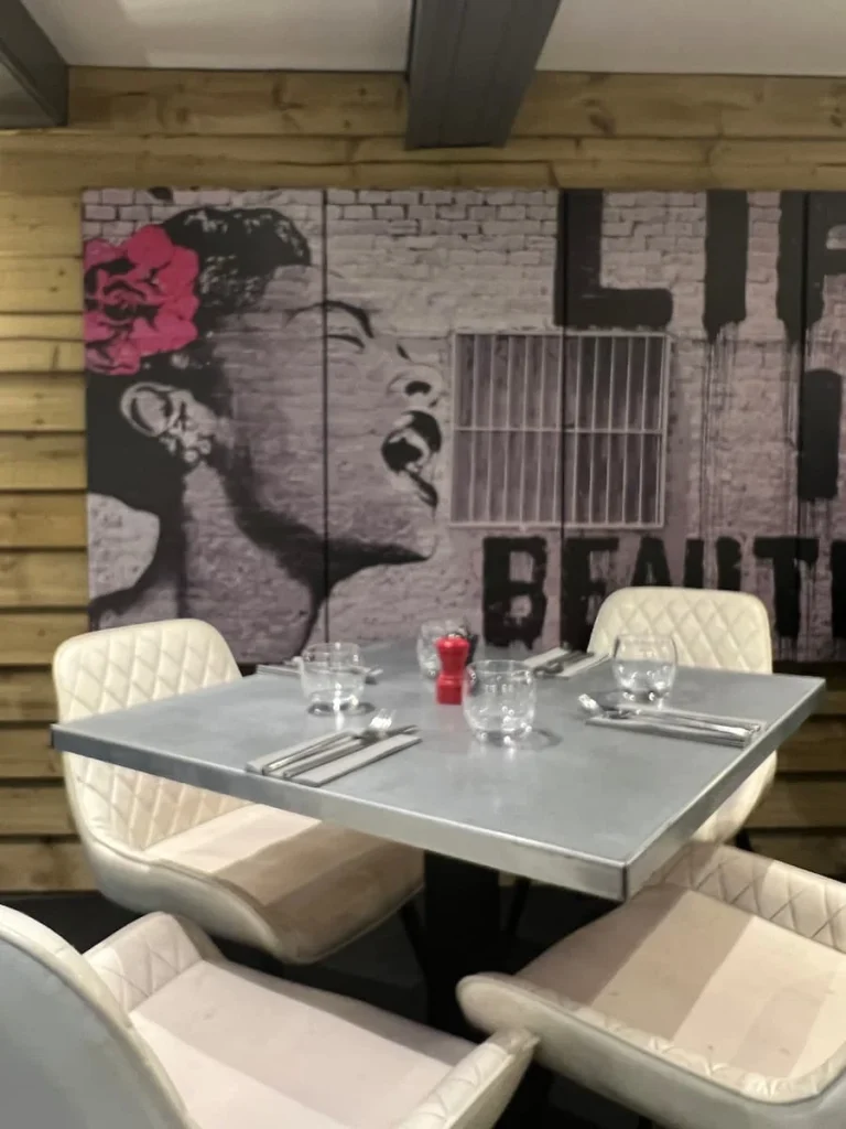 Image on wall as wallpaper of a South American lady with a pink flower in hair at Urban Fresh, Ely