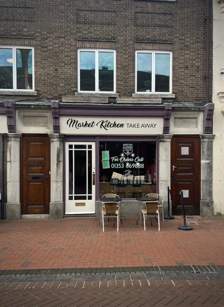 Market Kitchen Takeaway exterior, Ely. the exterior has a cream facade with black signage