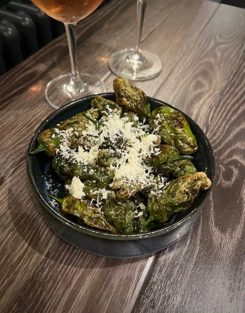 A small round dish of Padron peppers topped with Halloumi crumb at Urban Fresh, Ely