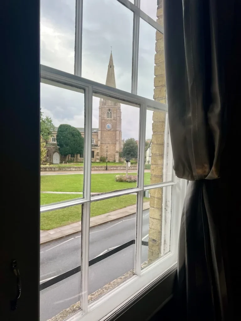 A church view from the suite window at Poet's House Hotel in Ely. The Silver curtain is draped back to reveal the early evening sky an dviews.