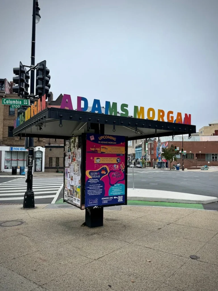 Adams Morgan multi-coloured Sign on a bill board near traffic lights in Washington DC. Adams Morgan has a few sustainable hotels in Washington DC